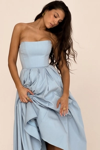 Detailed view of silky light blue strapless dress with elegant pleats and gold jewelry