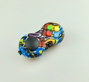 Top view of graffiti fidget controller with black joystick and colorful buttons on white