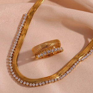 Detail of 18K gold plated herringbone necklace and ring set with sparkling zircons