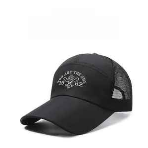 Detail of black mesh baseball cap featuring white embroidery of You Are The One and 1982