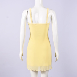 Detail of yellow mesh mini dress featuring ruffled lettuce edges and layered fabric