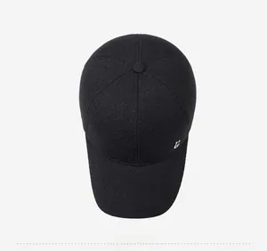 Close-up of black wool blend baseball cap showing textured fabric and metallic logo detail