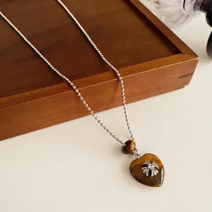 Tiger eye heart pendant necklace with silver cross on a minimalist bead chain