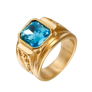 Macro detail of men's vintage gold titanium ring with a square blue gemstone inlay