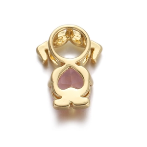 Macro detail of gold girl pendant with pink heart-shaped zircon and polished finish