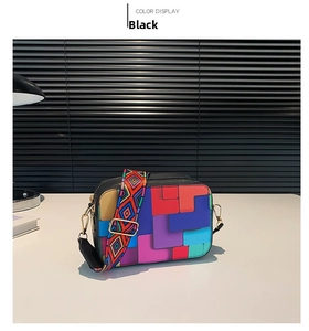 Detail of black crossbody bag with colorful geometric patterns and wide ethnic strap