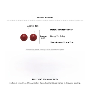 Detailed view of 2cm dark red shell pearl earrings with 925 silver needles