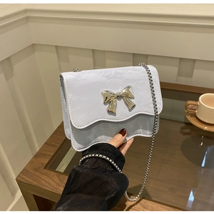 Light blue crossbody bag with marble pattern, wavy edge flap and silver bow clasp