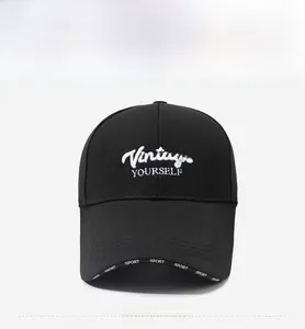 Detailed front view of black baseball cap with white Vintage embroidery and sport brim