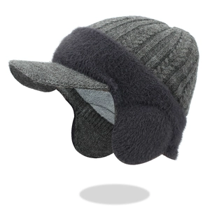 Men's winter knit hat with dark grey visor and thick faux fur ear flaps lining