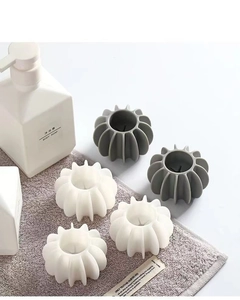 Close-up of gray and ivory silicone laundry balls on a towel in a bathroom setting