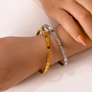 Elegant gold and silver stainless steel star bangles with zircon inlay on female wrist