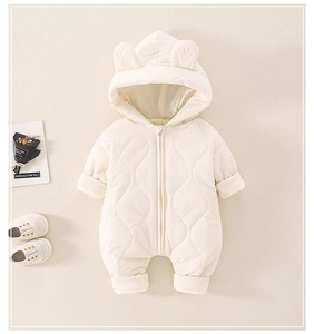 Detail of white quilted baby romper with bear ears and ribbed cuffs for warmth