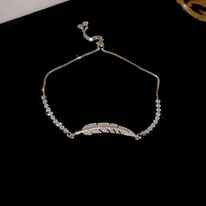 Macro shot of adjustable slider bracelet with cubic zirconia feather and claw chain detail