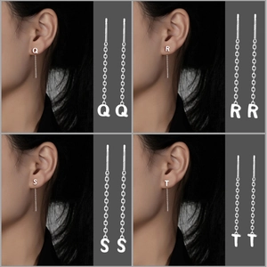 Detail of S999 silver letter threader earrings featuring Q, R, S, T alphabet charms