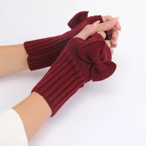 Detailed knit texture and bow accent on wine red fingerless gloves for women