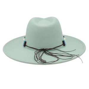 Detail of mint green fedora hat featuring colorful beaded band and brown tassels