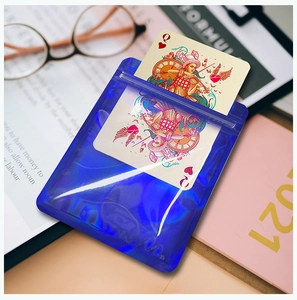Blue holographic resealable bag for jewelry showing transparency with a playing card inside