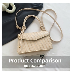 Close-up of pleated beige faux leather shoulder bag with gold hardware and square flap