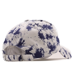 Detail of blue and white tie-dye baseball cap with silver metal adjustable buckle