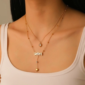 Gold layered stainless steel MOM necklace with heart pendants and crystal tassel