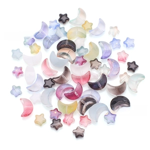 Close-up of iridescent star and moon glass beads in mixed colors for DIY jewelry making