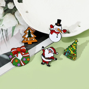 Detailed view of five colorful Christmas enamel pins featuring Santa, Snowman and Trees