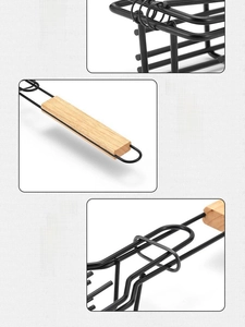 Detail view of wooden handle and flat ring clasp on metal barbecue grilling basket