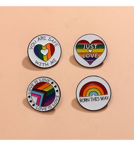 Detailed view of rainbow LGBTQ+ badges with slogans including Love is Love and Just Love