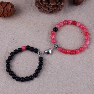 Close-up of 8mm natural stone bead bracelets with magnetic heart charm on linen