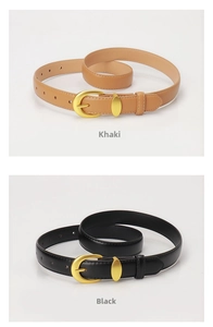 Detail of khaki and black leather belts with golden alloy pin buckles and fine stitching