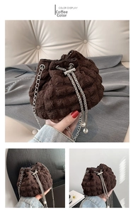 Detail of coffee brown drawstring bucket bag with wavy texture and pearl chain strap