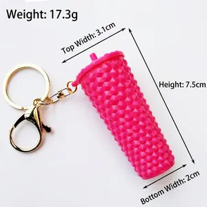 Macro detail of pink studded miniature cup keychain with dimensions 3.1x7.5 cm