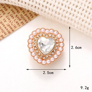 Detail view of heart-shaped shoe charm with pink pearls and rhinestones 2.5cm x 2.6cm