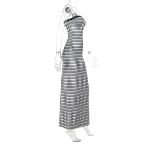 Detailed side view of slim fit black and white striped strapless maxi dress on model