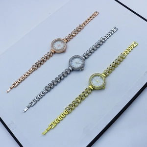 Detail of lady's quartz watches with leaf-shaped crystal straps in gold and silver