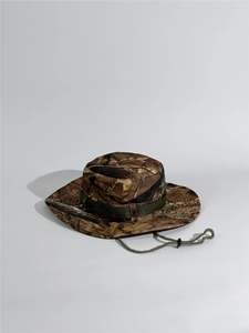 Macro detail of jungle camouflage boonie hat with tactical webbing and adjustable cord