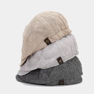 Close-up of linen fabric texture and side leather tab with vintage metal button detail