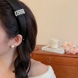 Elegant black satin headband with three rows of pearls and matching pearl earrings for women
