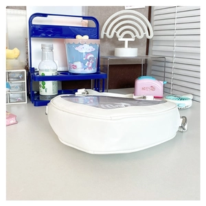 Detailed view of heart-shaped white ita bag with transparent PVC window for badge display