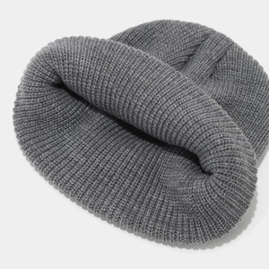 Close-up of the grey knitted beanie showing detailed ribbed texture and soft warm fibers