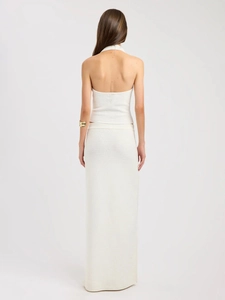 Rear view of cream knit two-piece set featuring backless halter top and maxi skirt