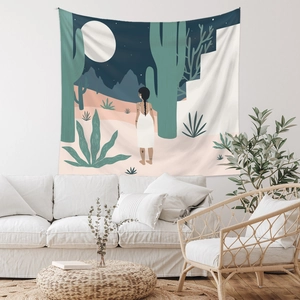 Detailed desert moonlit tapestry featuring cacti and artistic female figure above a sofa