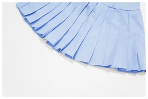 Detailed close-up showing the uniform pleats and smooth texture of the light blue sports skirt