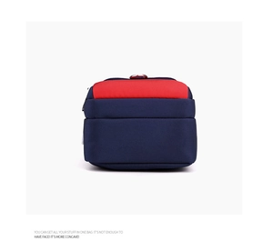 Detail view of durable navy nylon bag with red top panel and reinforced handle