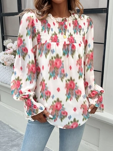Detail of floral long sleeve shirt with smocked yoke and vibrant blossom print