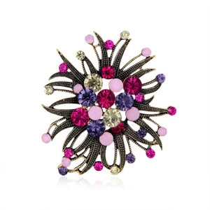 Detailed macro view of vintage bronze flower brooch with pink and purple rhinestones