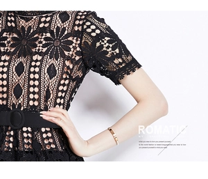 Detail of hollow-out floral lace dress with semi-high collar and belted waistline