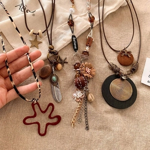 Detailed view of bohemian necklaces featuring ethnic star, feather and shell pendants