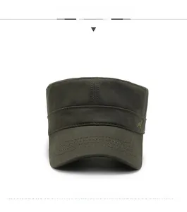 Detailed front view of olive green flat top army cap with gold bird embroidery